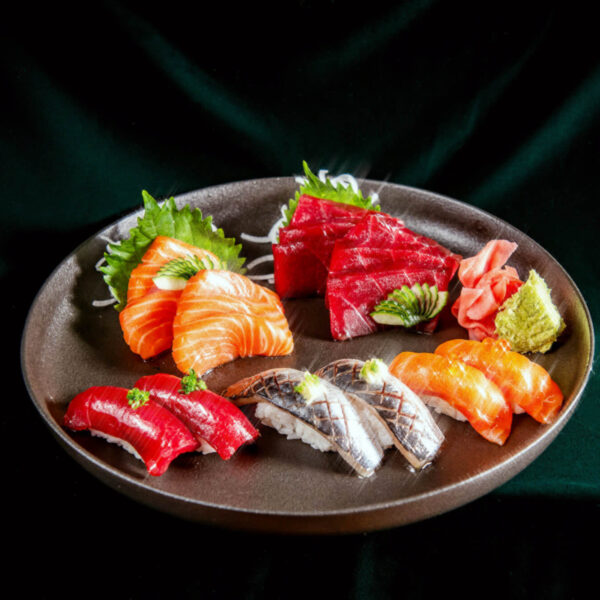 Platter of sushi against green velvet backdrop at Aera restaurant in Toronto