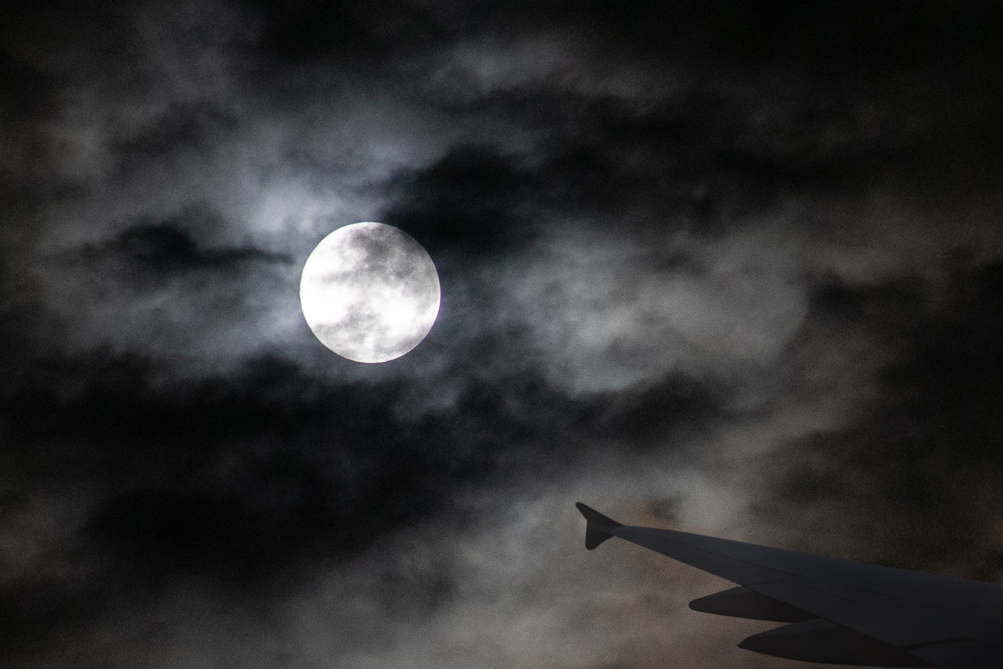 View from an airplane window showing a spooky sky